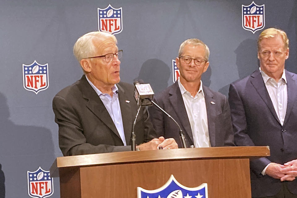 Rob Walton speaks at the NFL owners meeting in Bloomington, Minn., Tuesday, Aug. 9, 2022, as son-in-law Greg Penner, center, and NFL commissioner Roger Goodell look on, Tuesday, Aug. 9, 2022. The record $4.65 billion sale of the Denver Broncos to Walmart heir Rob Walton and his daughter and son-in-law was unanimously approved Tuesday by NFL owners, the expected final step in the transfer from the family of the late Pat Bowlen.