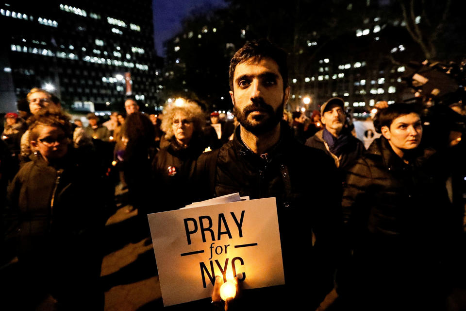 <p>NOV. 1, 2017 – People gather for a candlelight vigil for victims of the pickup truck attack at Foley Square in New York City. (Photo: Jeenah Moon/Reuters) </p>