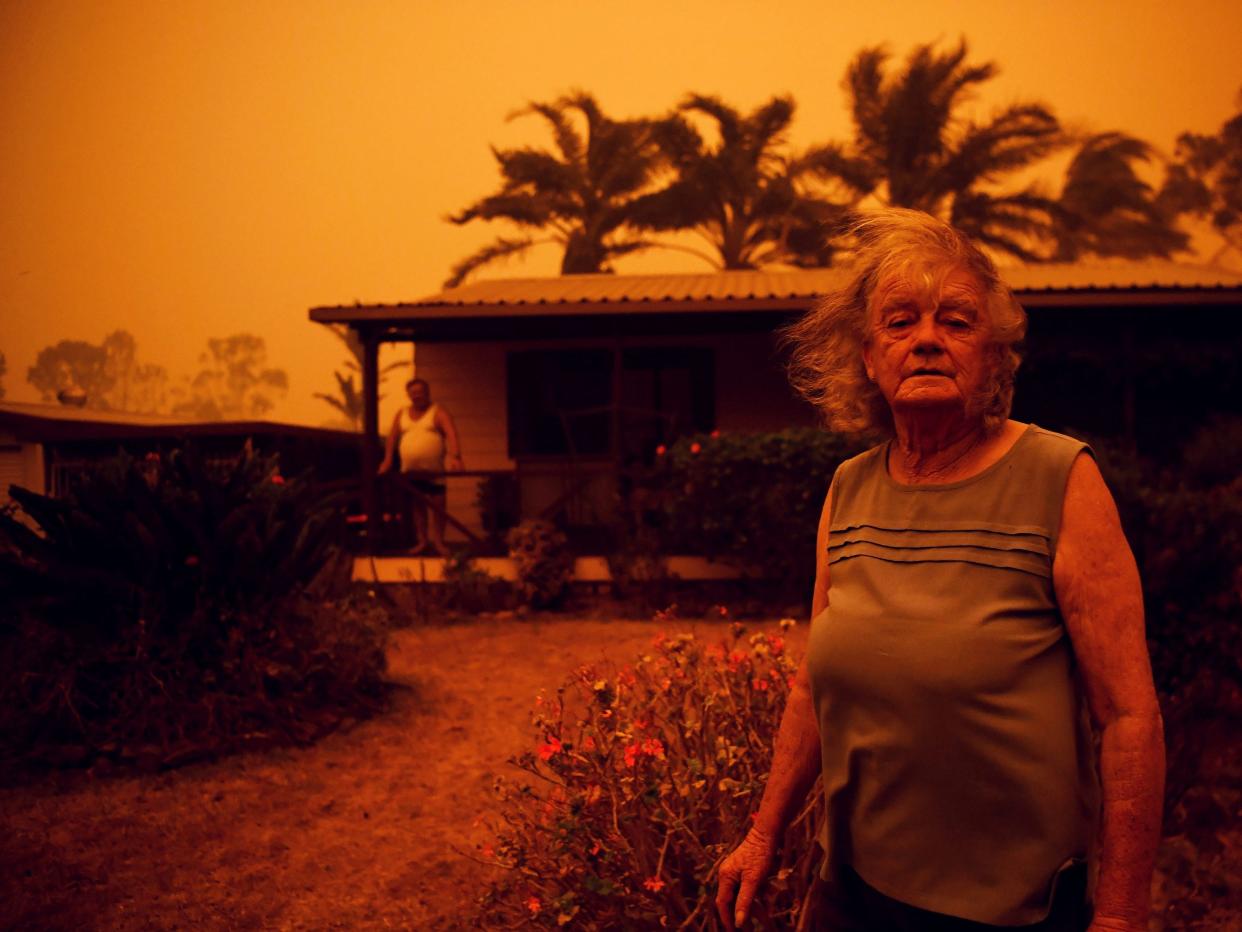 Nancy Allen and Brian Allen stand outside the house as high winds push smoke and ash from the Currowan Fire towards Nowra, New South Wales, Australia January 4, 2020. REUTERS/Tracey Nearmy