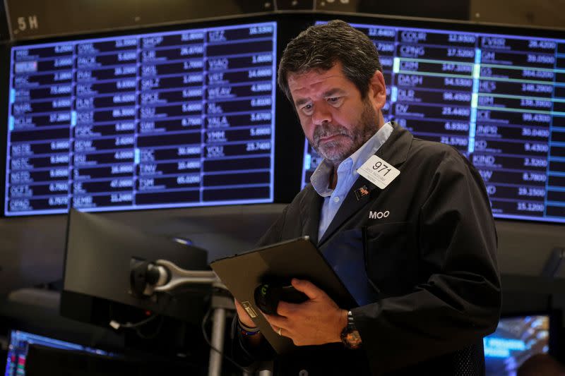 FILE PHOTO:Traders work on the floor of the NYSE in New York