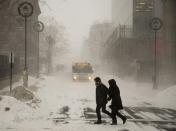 Pedestrians brave the blizzard conditions in Halifax on Friday, Jan. 3, 2014. The region is in the grip of unseasonably cold temperatures with heavy snow and high winds. THE CANADIAN PRESS/Andrew Vaughan
