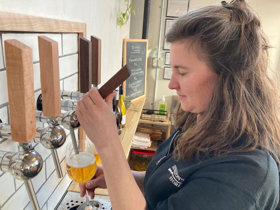 Lillian MacNamara, co-owner of Freak Folk Bier, pours a beer at the Waterbury brewery March 4, 2022.