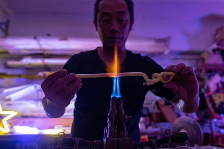 Despite a waning client-base, 50-year-old Wu Chi-kai continues in the trade, working with glass tubes dusted inside with fluorescent powder and containing various gases including neon or argon, as well as mercury, to create different colours