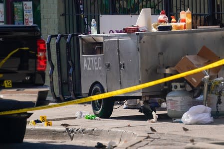 Evidence markers lay on the ground near a hotdog stand after a mass shooting in Dayton