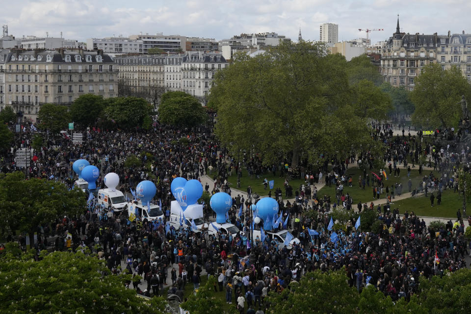 Protesters arrive Place de la Nation during a demonstration, Monday, May 1, 2023 in Paris. Across France, thousands marched in what unions hope are the country's biggest May Day demonstrations in years, mobilized against President Emmanuel Macron's recent move to raise the retirement age from 62 to 64. (AP Photo/Thibault Camus)