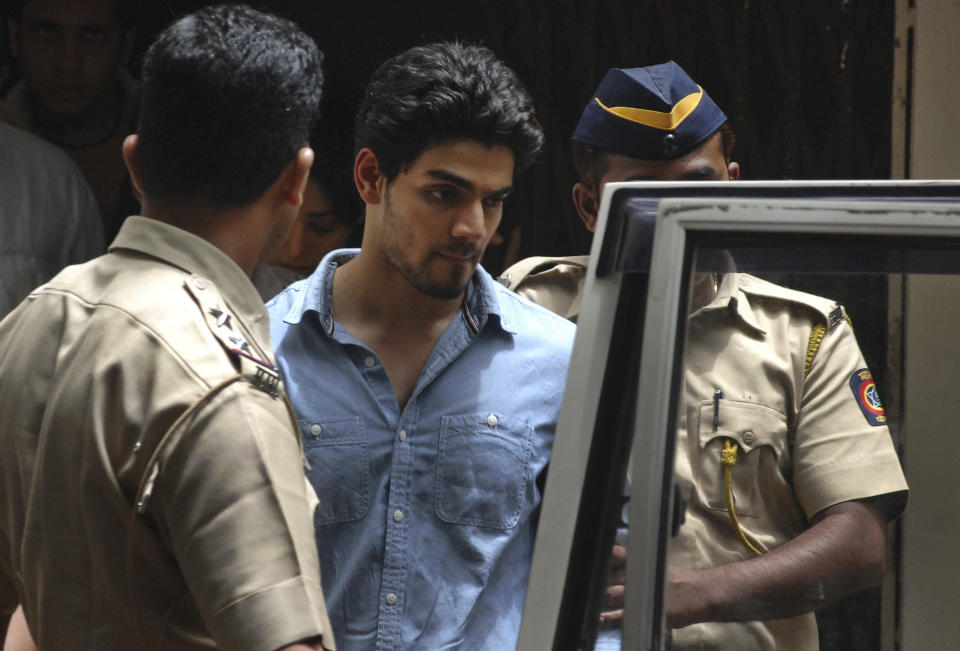 Suraj Pancholi, the son of Bollywood couple Aditya Pancholi and Zarina Wahab is escorted by police as he leaves after appearing before a court in Mumbai, India, Tuesday, June 11, 2013. Pancholi, has been arrested on suspicion of abetting the suicide of his girlfriend, actress Jiah Khan, police said. Khan, 25, committed suicide at her home in Mumbai last week. (AP Photo)