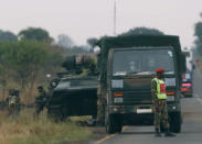 Soldiers stand beside military vehicles just outside Harare, Zimbabwe November 14, 2017. REUTERS/Philimon Bulawayo