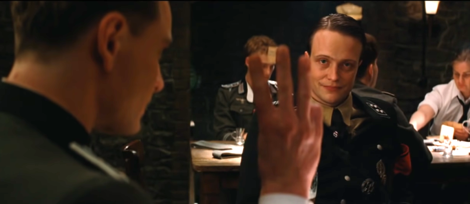 Michael Fassbender in Inglourious basterds holding up three fingers