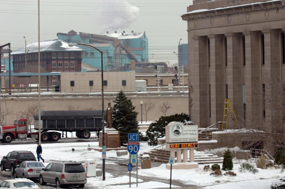 FILE - In this Dec. 5, 2007 file photo U.S. Steel's sprawling Gary Works plant in Gary, Ind., sits a short distance from Gary's City Hall, right. U.S. Steel said Monday, April 7, 2014 that Gary Works, its largest mill, is on limited production after a shortage of vital iron ore due to the ice covering Lake Superior had temporarily shut down its furnaces. (AP Photo/Joe Raymond, File)