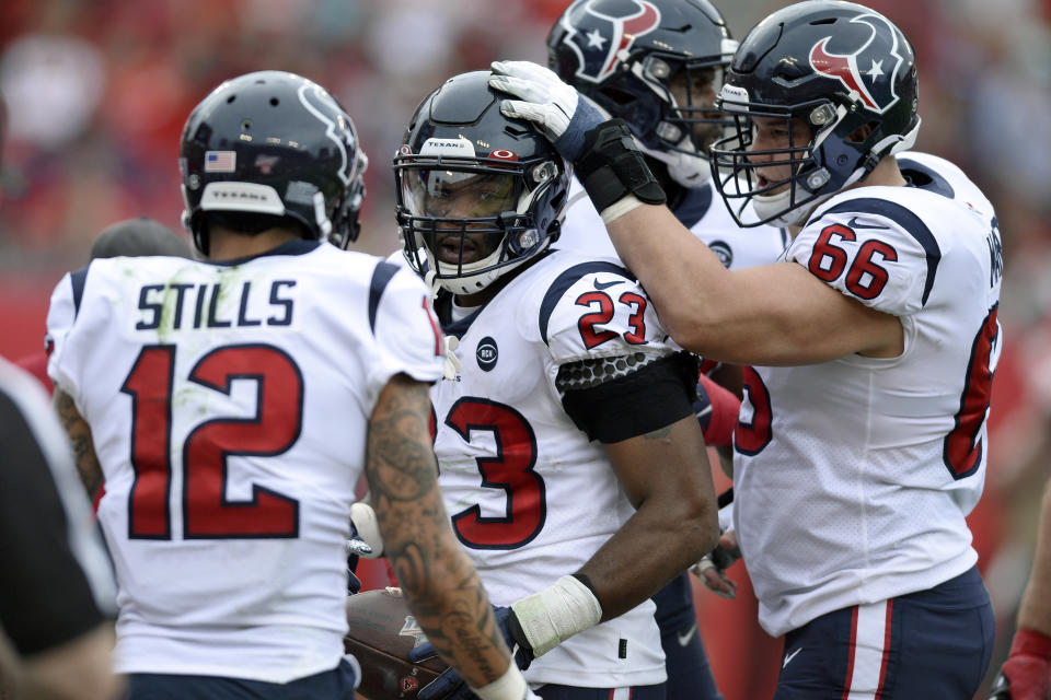 Houston Texans running back Carlos Hyde (23) celebrates with wide receiver Kenny Stills (12) and center Nick Martin (66) after his 1-yard touchdown run against the Tampa Bay Buccaneers during the first half of an NFL football game Saturday, Dec. 21, 2019, in Tampa, Fla. (AP Photo/Jason Behnken)