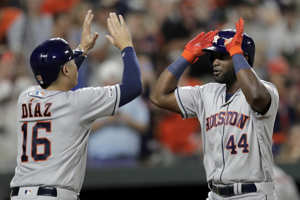 Houston Astros' Yordan Alvarez (44) is greeted at home by Aledmys Diaz (16) after Alvarez hit a grand slam off Baltimore Orioles relief pitcher Tayler Scott during the seventh inning of a baseball game Saturday, Aug. 10, 2019, in Baltimore. (AP Photo/Julio Cortez)