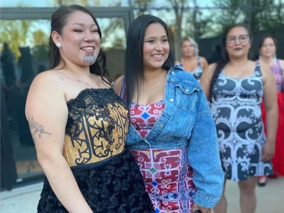 Model Rosalie Labillois, left, wears a gown with a birchbark bodice created by Sgoagani Wecenisqon, right, at a fashion show in Fredericton last weekend. (Submitted by Sgoagani Wecenisqon - image credit)