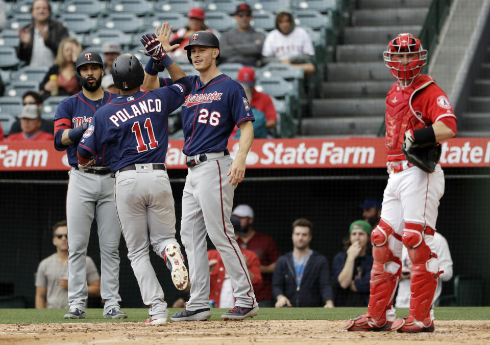 Minnesota Twins' Jorge Polanco (11) celebrates his two-run home run with teammate Max Kepler (26) during the second inning of a baseball game against the Los Angeles Angels Thursday, May 23, 2019, in Anaheim, Calif. (AP Photo/Marcio Jose Sanchez)