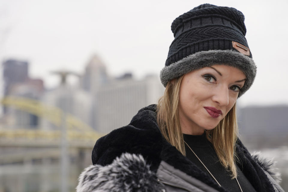 In this Monday, Feb. 8, 2021, photo, Allissa Star poses for a photograph along the north shore of the Allegheny River in Pittsburgh. Starr worked about a week every month at a brothel in Pahrump, Nev., outside of Las Vegas. Then the pandemic led to the shuttering of Nevada's licensed bordellos, the only place where prostitution is legal in the state, and they have remained closed since March, leaving sex workers like Starr struggling to pay the bills and turning to alternatives like "virtual" dates. (AP Photo/Keith Srakocic)