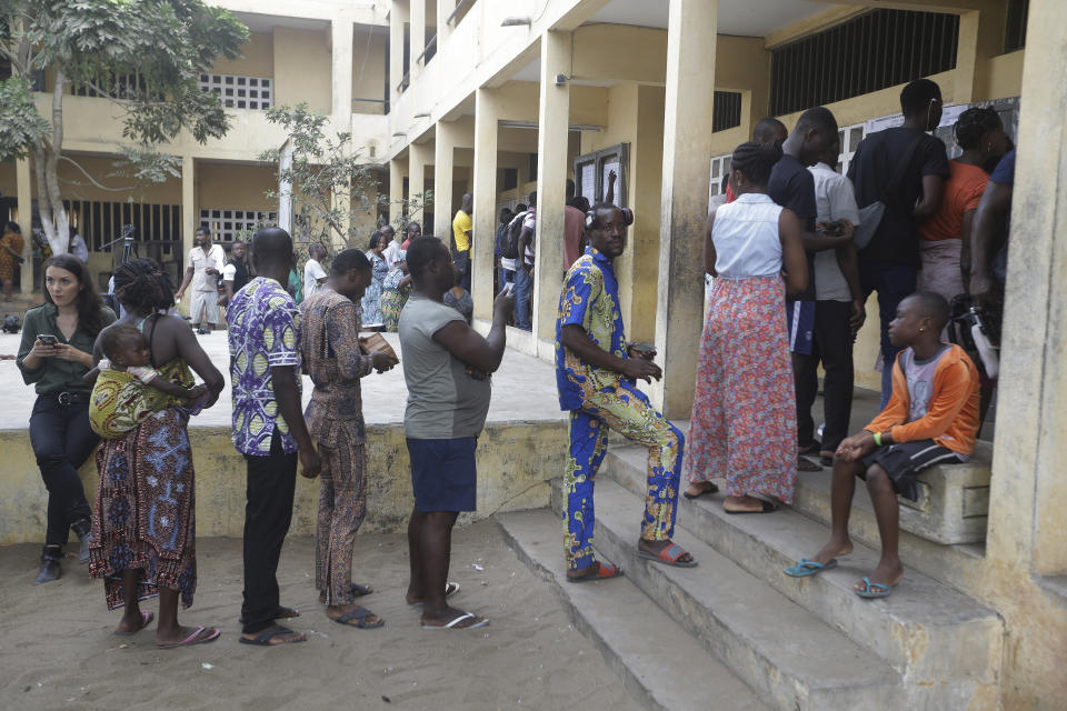 People wait to cast their votes in the presidential election in Lome, Togo, Saturday, Feb. 22, 2020. The West African nation of Togo is voting Saturday in a presidential election that is likely to see the incumbent re-elected for a fourth term despite years of calls by the opposition for new leadership. (AP Photo/Sunday Alamba)