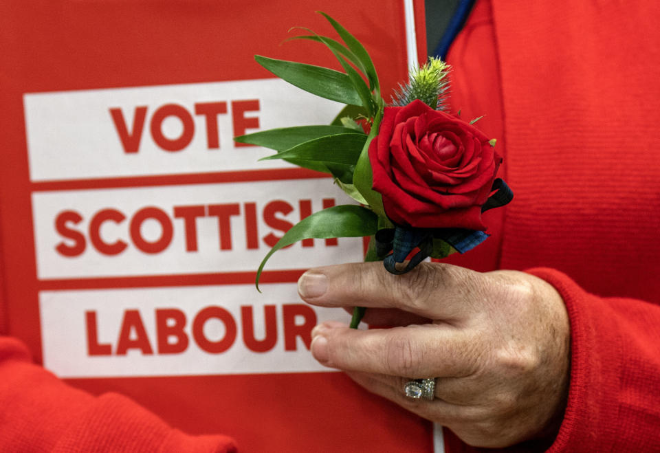 A Scottish Labour supporter appears in the count hall at the South Lanarkshire Council Headquarters in Hamilton, Scotland, for the Rutherglen and Hamilton West by-election, Thursday, Oct. 5, 2023. The seat was vacated after former SNP MP Margaret Ferrier was ousted in a recall petition. Ferrier was kicked out of the SNP for breaching Covid regulations by traveling between London and Glasgow after testing positive for the virus. (Jane Barlow/PA via AP)