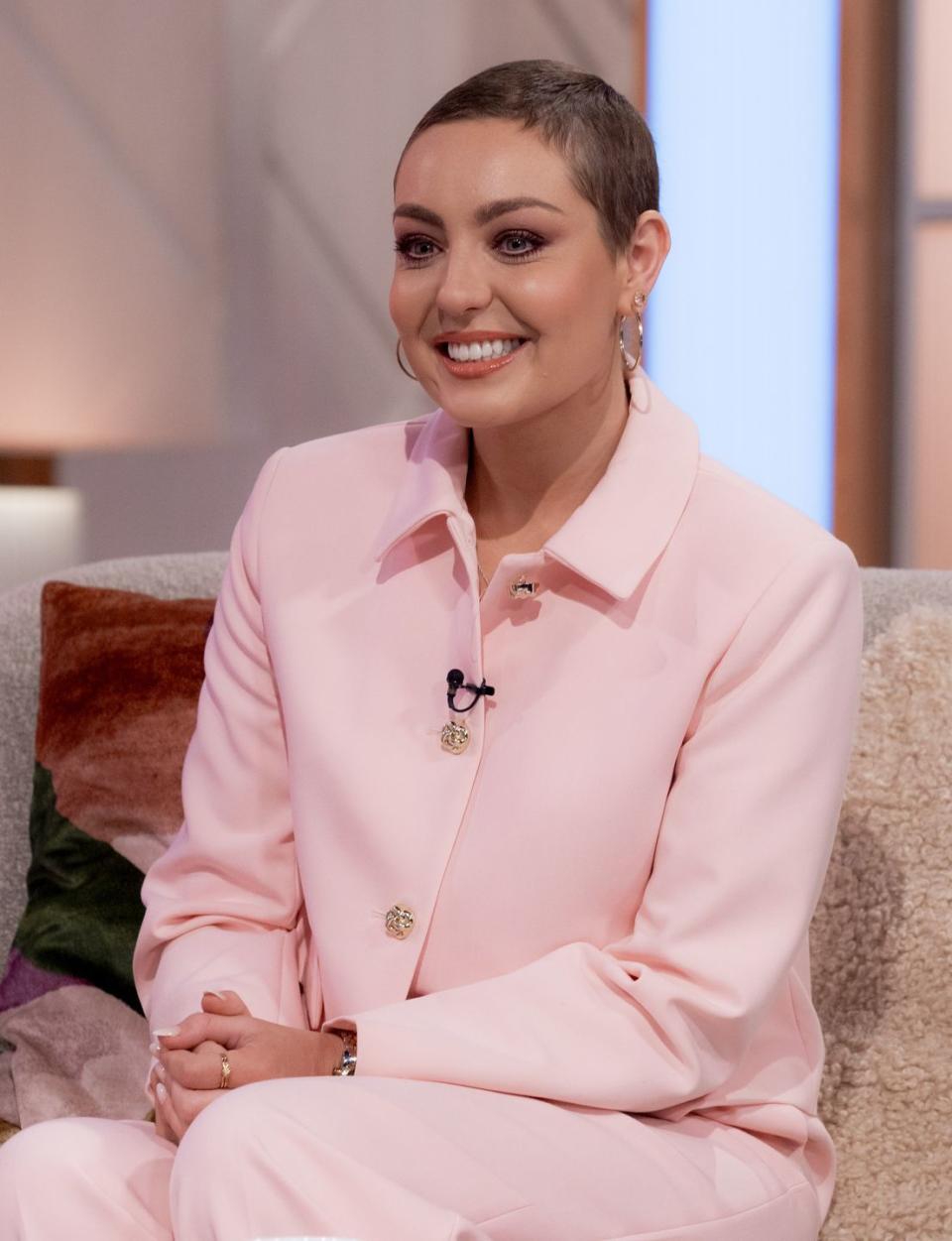 amy dowden wearing a big smile and a pale pink shirt on lorraine