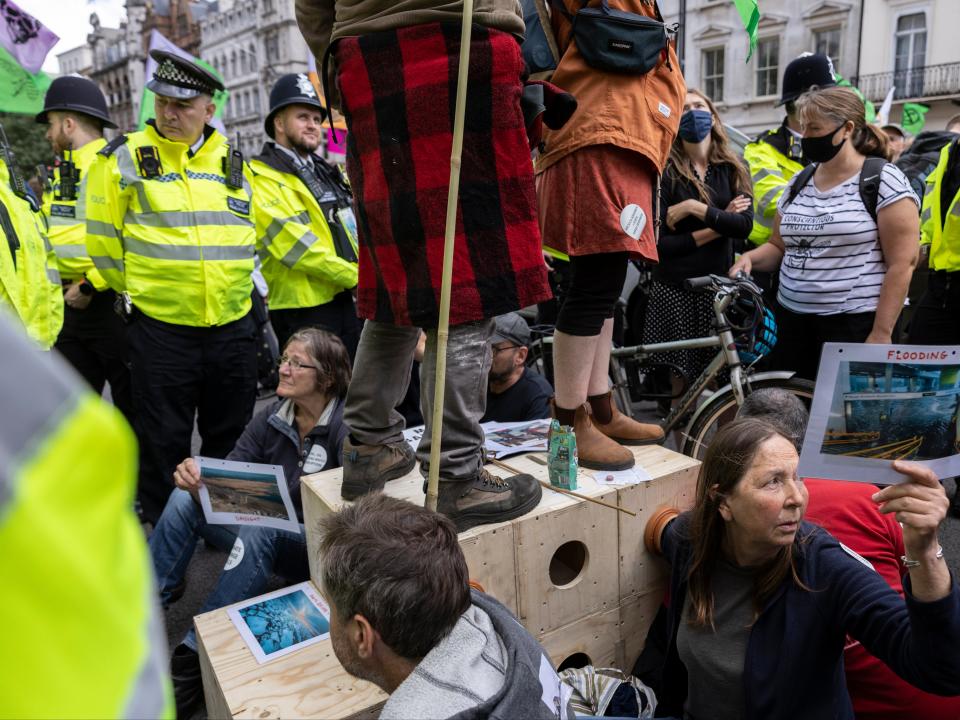 XR protesters lock themselves into position outside HMRC earlier (Getty)