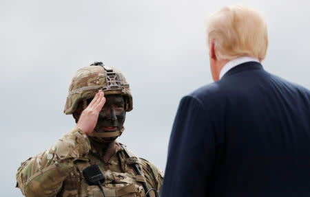 A soldier from the U.S. Army's 10th Mountain Division salutes U.S. President Donald Trump during the president's visit to Fort Drum, New York, U.S., August 13, 2018. REUTERS/Carlos Barria