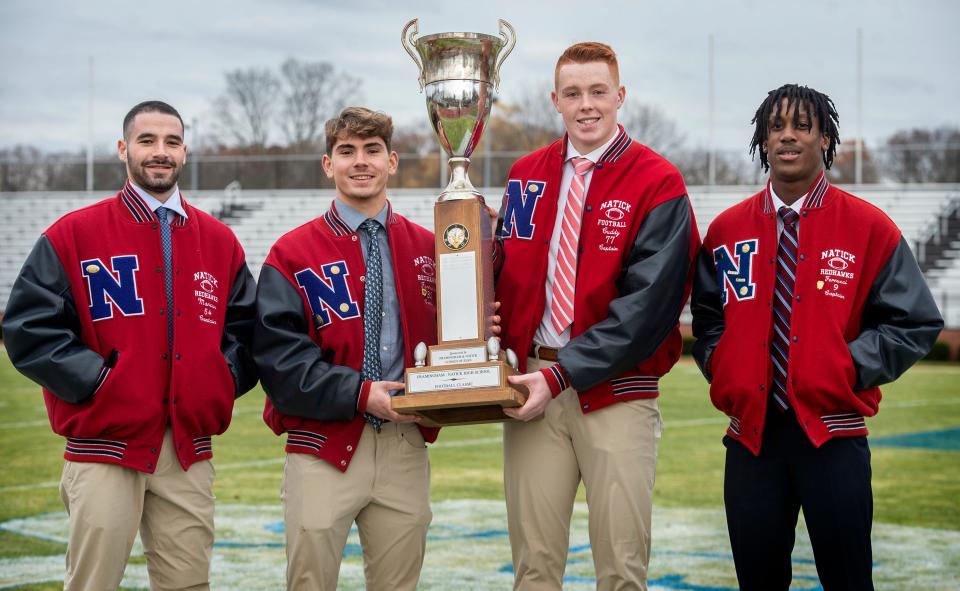 Natick High School football captains from left: Jared Marcus, Teddy Ferrucci, Jack Cuddy, and Arnold Kawere, at Bowditch Field, Nov. 21, 2023.