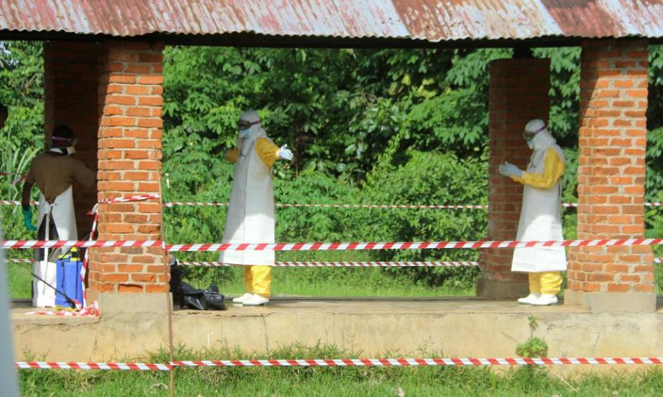 A health worker is sprayed with chlorine after visiting the isolation ward at Bikoro hospital.