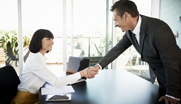 Businesswoman welcoming man to meeting