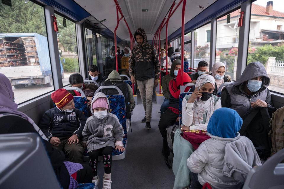 Migrants board a bus on their way to Athens after trying to cross the Greek - Albanian border, in Mesopotamia village, northern Greece, on Tuesday, Sept. 28, 2021. A relatively smooth section of Greece's rugged border with Albania is turning into a major thoroughfare north for migrants in Greece seeking a better life in Europe's prosperous heartland. (AP Photo/Giannis Papanikos)