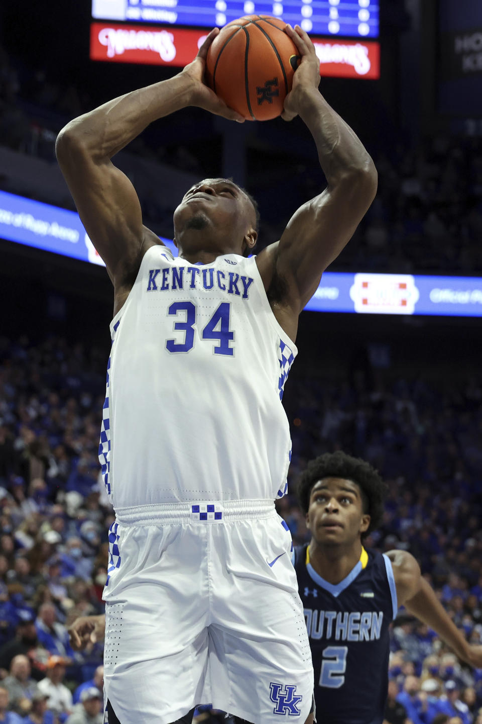 Kentucky's Oscar Tshiebwe (34) goes up for a dunk in front of Southern University's J'Quan Ewing (2) during the first half of an NCAA college basketball game in Lexington, Ky., Tuesday, Dec. 7, 2021. (AP Photo/James Crisp)