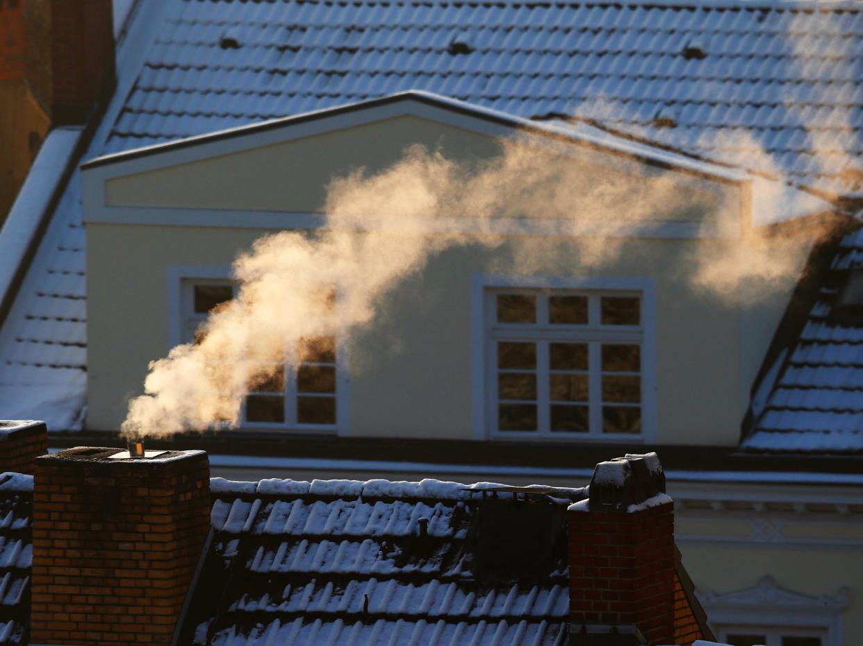 Snow on a roof with a chimney.