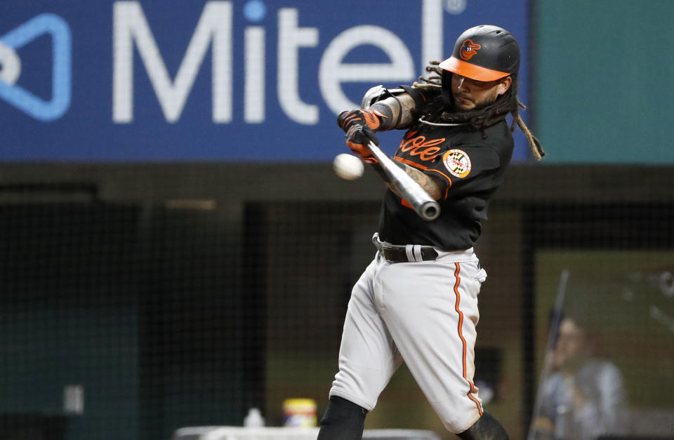 Baltimore Orioles' Freddy Galvis hits a double during the fifth inning of the team's baseball game against the Texas Rangers in Arlington, Texas, Friday, April 16, 2021. (AP Photo/Roger Steinman)