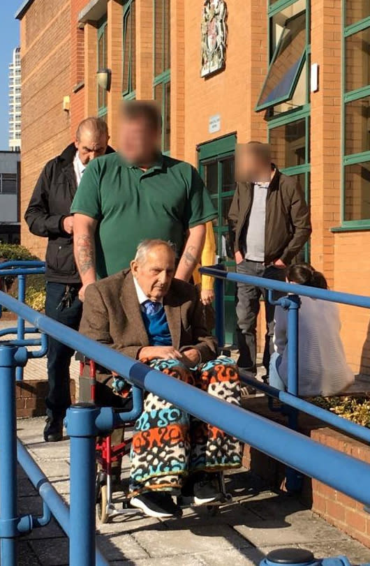 Dennis Cottee (front in wheelchair), with Jacques Cottee, in white shirt and black jacket behind, pictured leaving Swindon Crown Court (SWNS)