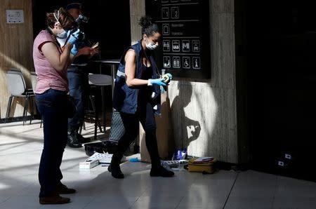 Belgian police lab technicians examine impacts of bullets inside Brussels central railway station after a suicide bomber was shot dead by troops in Brussels, Belgium, June 21, 2017. REUTERS/Francois Lenoir