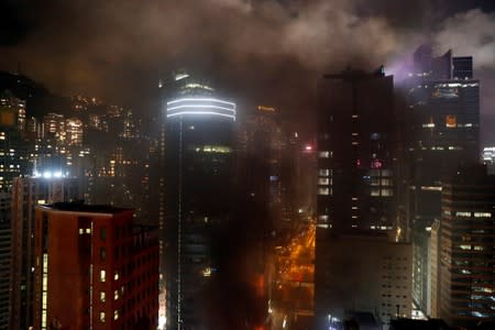 Smoke engulfs a street after anti-extradition bill demonstrators set a barricade on fire during a protest in Hong Kong