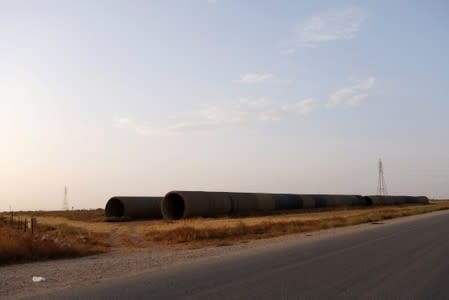 Damaged river water pipes are seen at a roadside in Benghazi