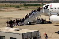 Houthi prisoners board a plane before heading to Sanaa airport as they are released by the Saudi-led coalition in a prisoner swap, at Sayoun airport