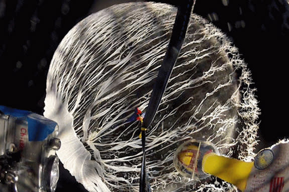 The balloon carrying Camilla Corona SDO, mascot of the NASA's Solar Dynamics Observatory (at lower right), bursts in the upper atmosphere during the flight on March 10, 2012.