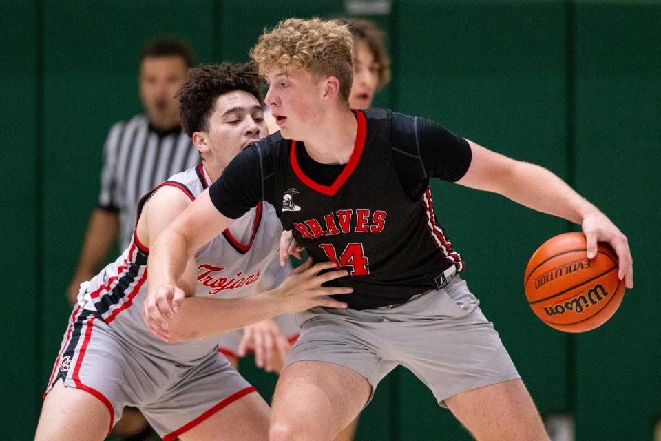 Brownstown Central High School's Jack Benter (14) drives the ball into the defense of Center Grove High School's Jalen Bundy (0) during Charlie Hughes Shootout basketball action, Saturday, June 24, 2023, at Westfield High School.
