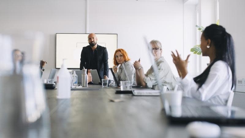 Black woman giving advice at meeting.