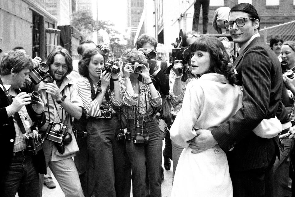 Cameras greet Margot Kidder and Christopher Reeve outside The News building during filming of 'Superman' on July 7, 1977.