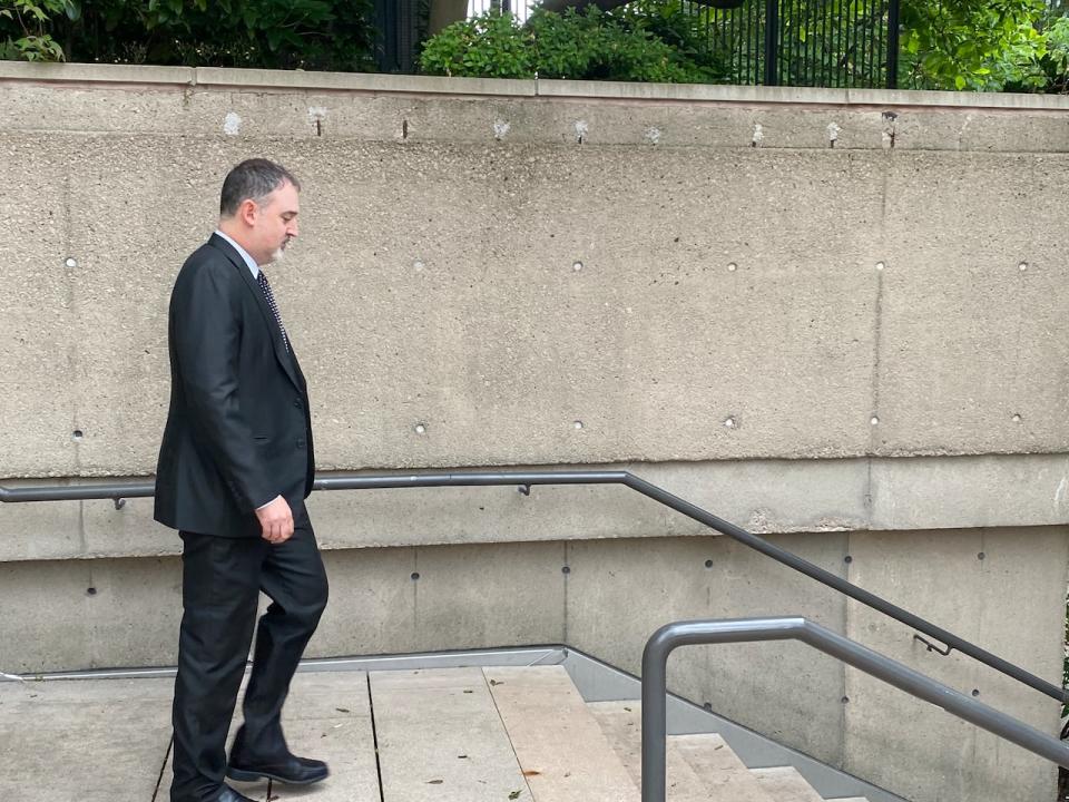 Jeremy Fenn, an RCMP forensic scientist, leaves court during a break in the first-degree murder trial of Ibrahim Ali. Fenn has spent two days testifying about his work analyzing forensic evidence from a 13-year-old girl's body. Ali is accused of killing the girl. He has pleaded not guilty.