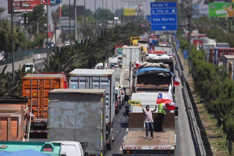 People block the road during a protest against the road tolls in the outskirts of Santiago