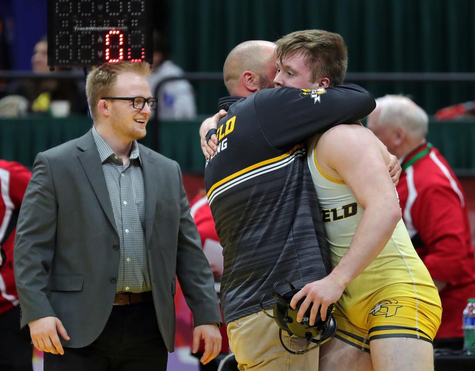 Keegan Sell of Garrettsville Garfield, right, celebrates with his coaches after winning the 190-pound Division III championship match in the OHSAA State Wrestling Tournament at the Jerome Schottenstein Center, Sunday, March 12, 2023, in Columbus, Ohio.