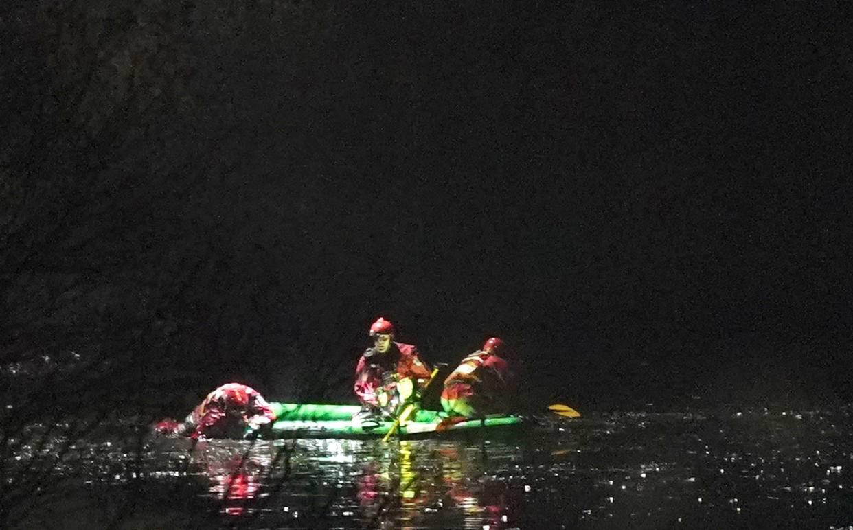 Emergency personnel search the lake at the scene in Babbs Mill Park in Kingshurst, Solihull after a serious incident where several people are believed to be in a critical condition after being pulled from the lake. Picture date: Sunday December 11, 2022.