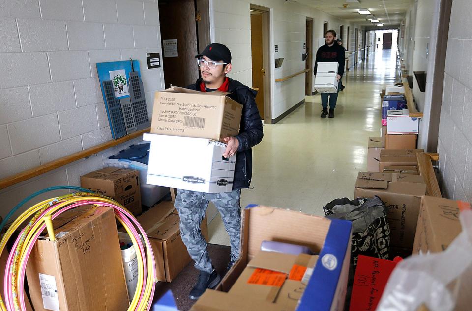 Junior Sam Abbott and freshman Brendan Dee carry boxes out of the Ashland Parenting Plus offices in the Ashland County Service Center and help move them to the agency's new office on Sandusky Street. Ashland University students participated in AU GIVS (Ashland University Gets Involved with Volunteer Service) on MLK Day Monday.