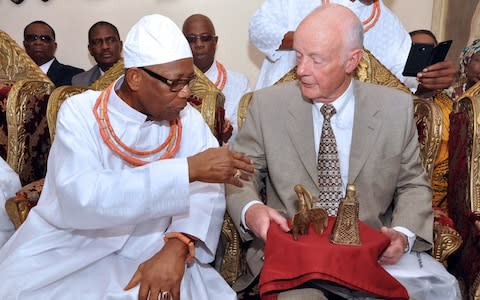 Retired hospital consultant Mark Walker (R) holding two bronze artefacts he returned to the kingdom of Benin in 2014. His grandfather was involved in the 1897 British raid in which they were taken. - Credit: Florian Plaucheur/AFP