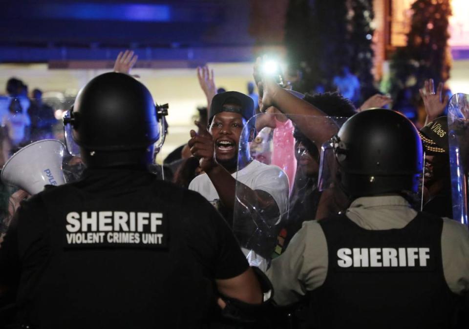 A protester yells at members of the Sheriff’s violent crimes unit Thursday during a protest in downtown Rock Hill.