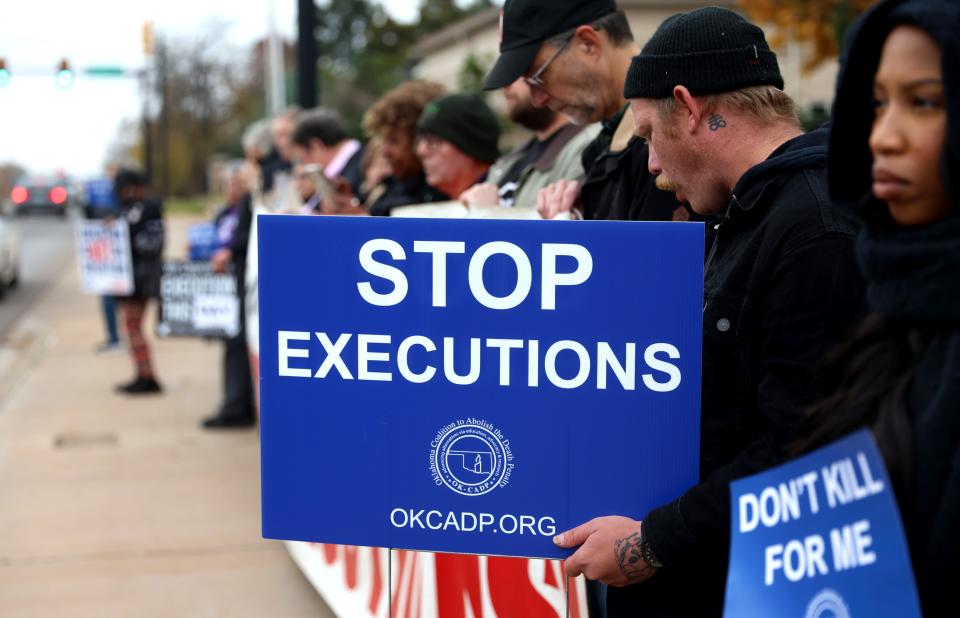 People stand Nov. 30 outside the Governor's Mansion during a prayer vigil against the death penalty in Oklahoma City.