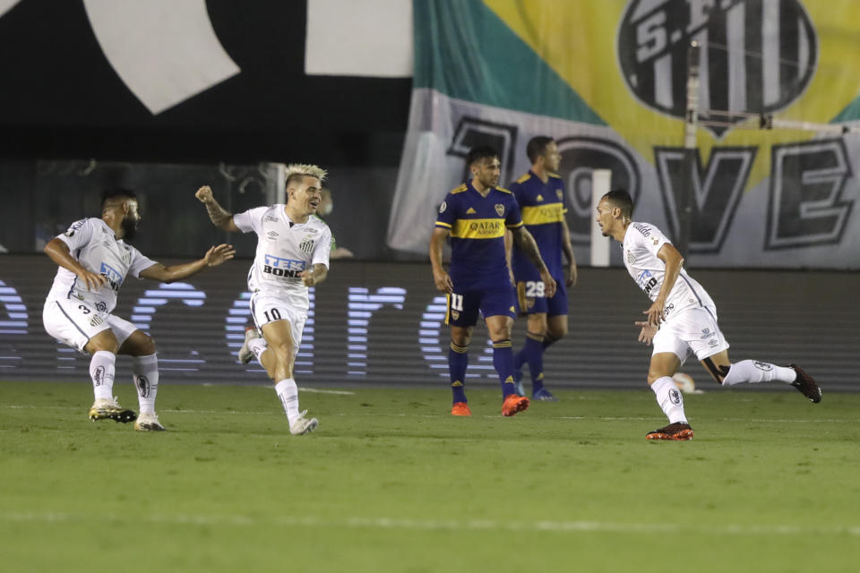 Diego Cristiano of Brazil's Santos, right, celebrates scoring his side's first goal during to a Copa Libertadores semifinal second leg soccer match against Argentina's Boca Juniors in Santos, Brazil, Wednesday, Jan. 13, 2021. (AP Photo/Andre Penner, Pool)