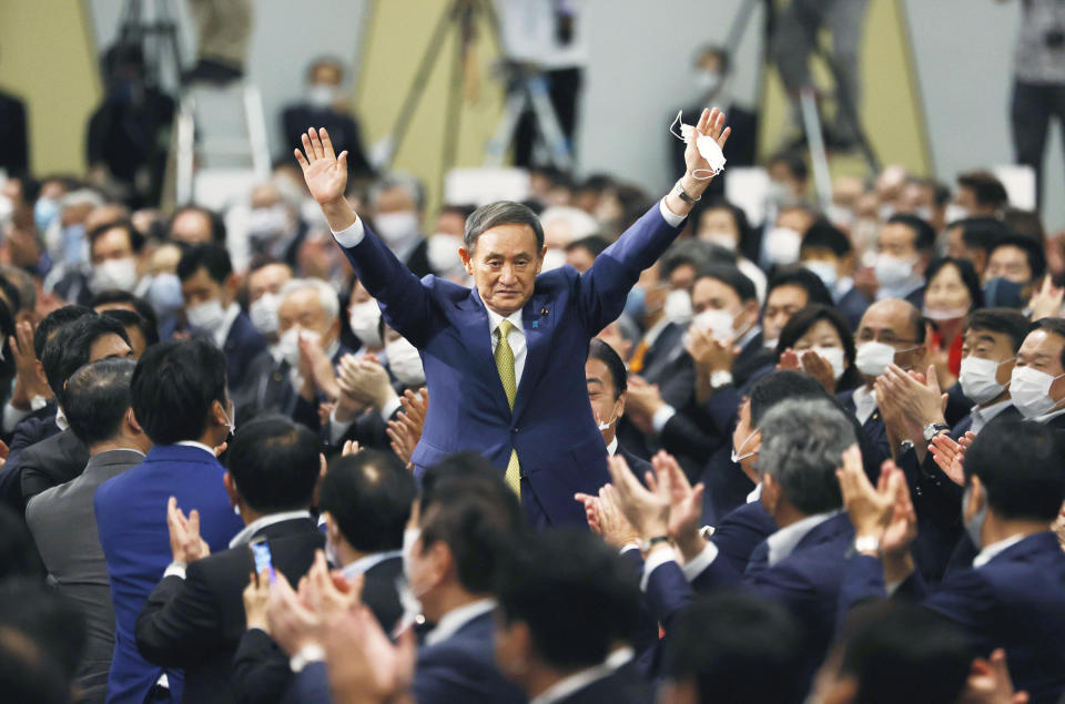 Japanese Chief Cabinet Secretary Yoshihide Suga acknowledges as he is elected as new head of Japan's ruling party at the Liberal Democratic Party's (LDP) leadership election in Tokyo Monday, Sept. 14, 2020. Suga was elected as the new head of Japan’s ruling party on Monday, virtually guaranteeing him parliamentary election as the country’s next prime minister. (Kyodo News via AP)