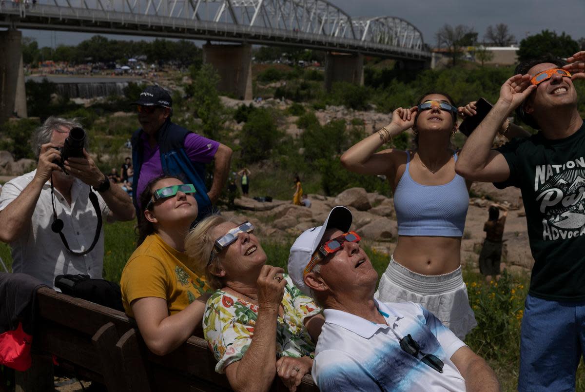 The Baressi family looks up at the sun Grenwelge Park, minutes before the total solar eclipse’s totality in Llano on April 8, 2024. The family traveled from across the United States to view the eclipse. The eclipse is expected to bring thousands of visitors to the area.